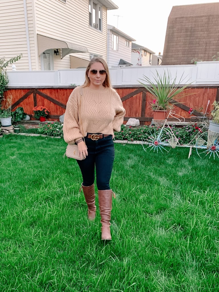 Brown balloon sleeve sweater styled with black jeans, boots and Gucci belt