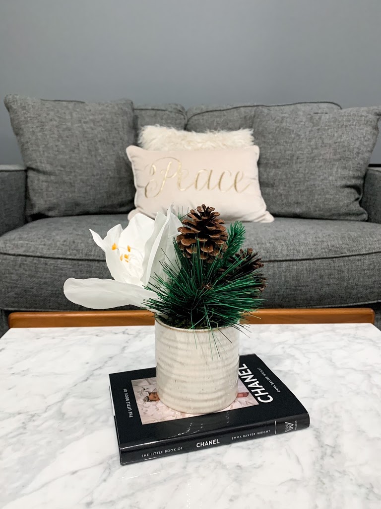 Pine cone and Chanel book coffee table Christmas decor