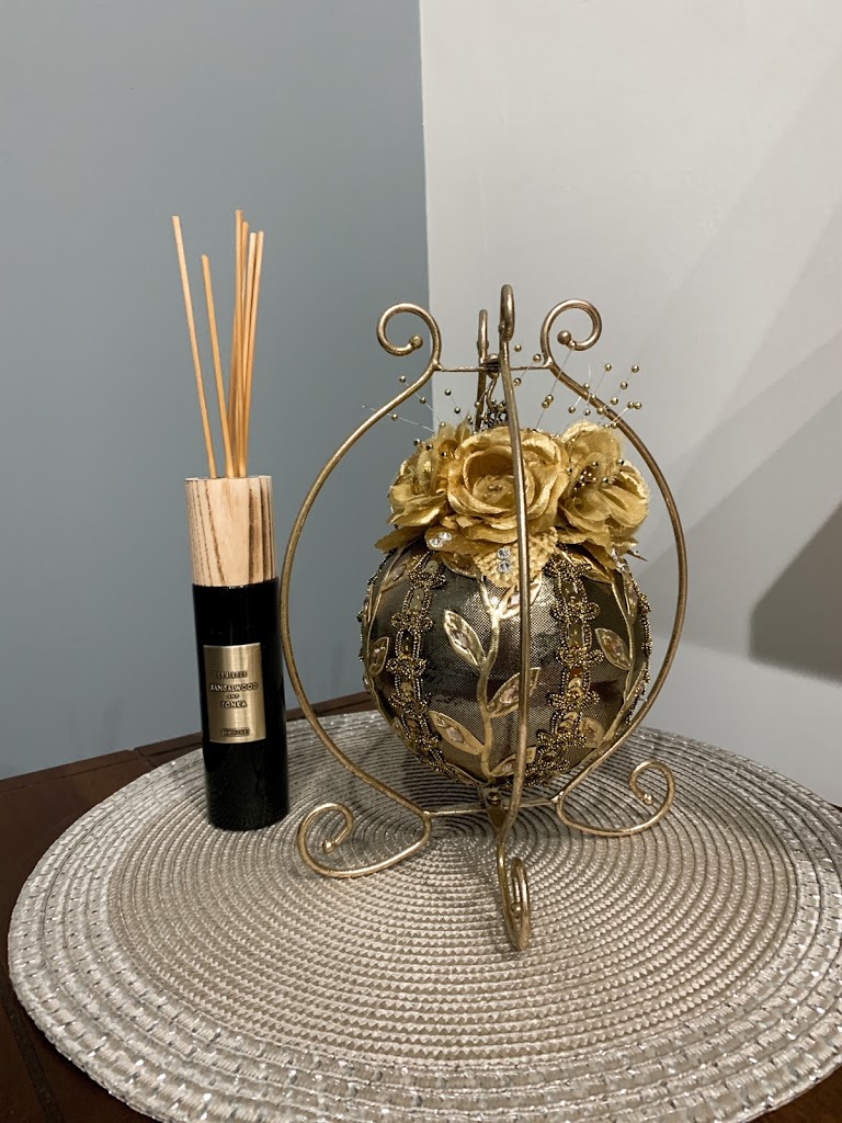 Gold handmade ornament and diffuser on the side table