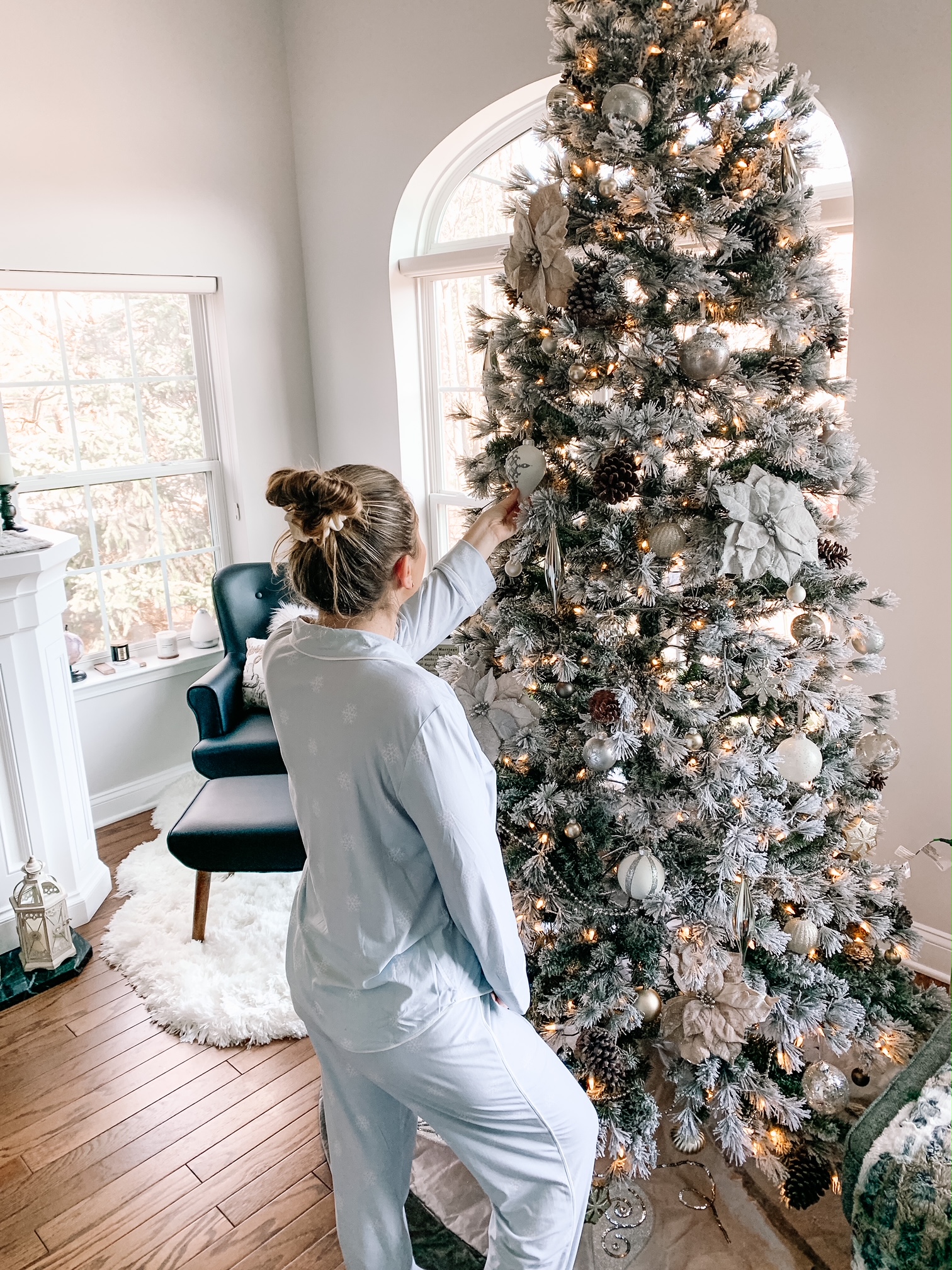 looking at a Christmas Tree wearing pajamas