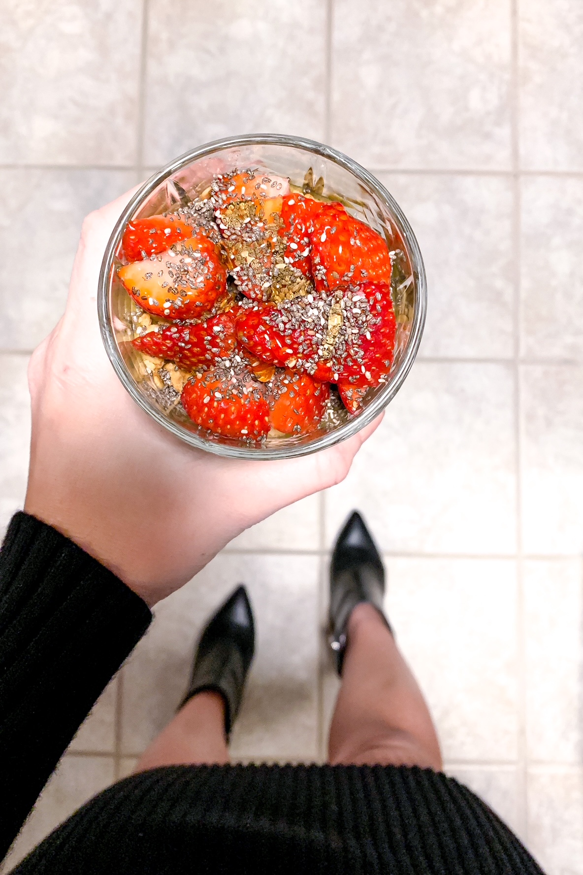 topped with granola, strawberries, chia seeds and honey