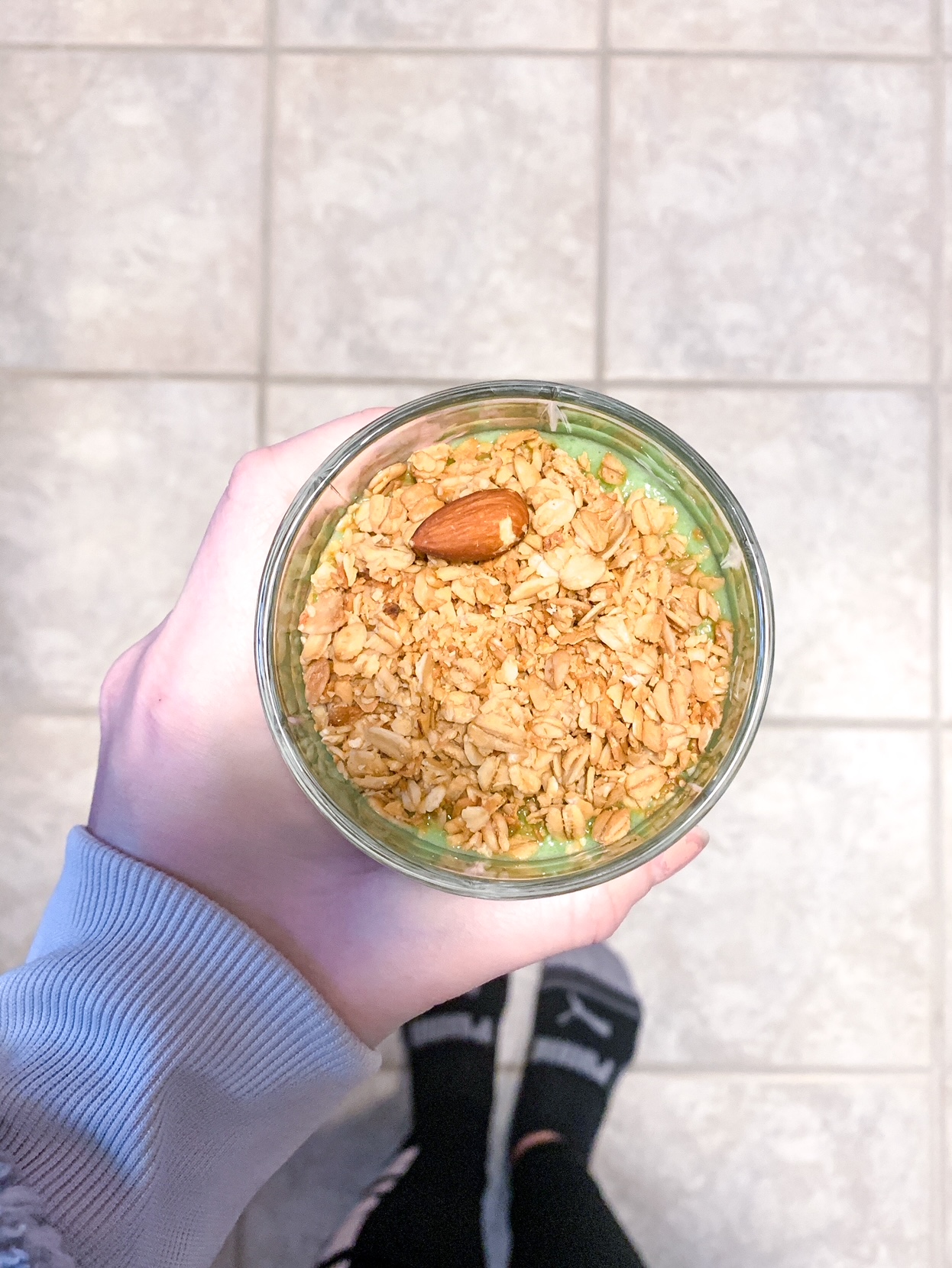 Coconut and almond granola on top of a green smoothie