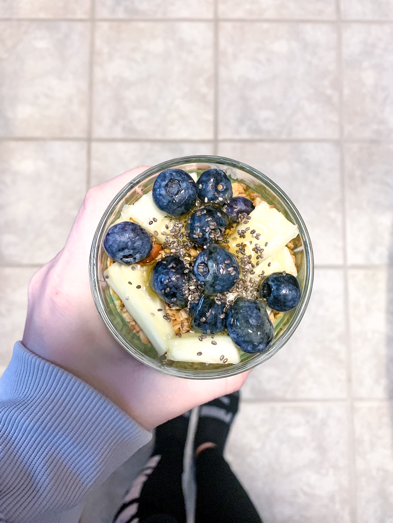 blueberries and pineapple toppings on a green smoothie