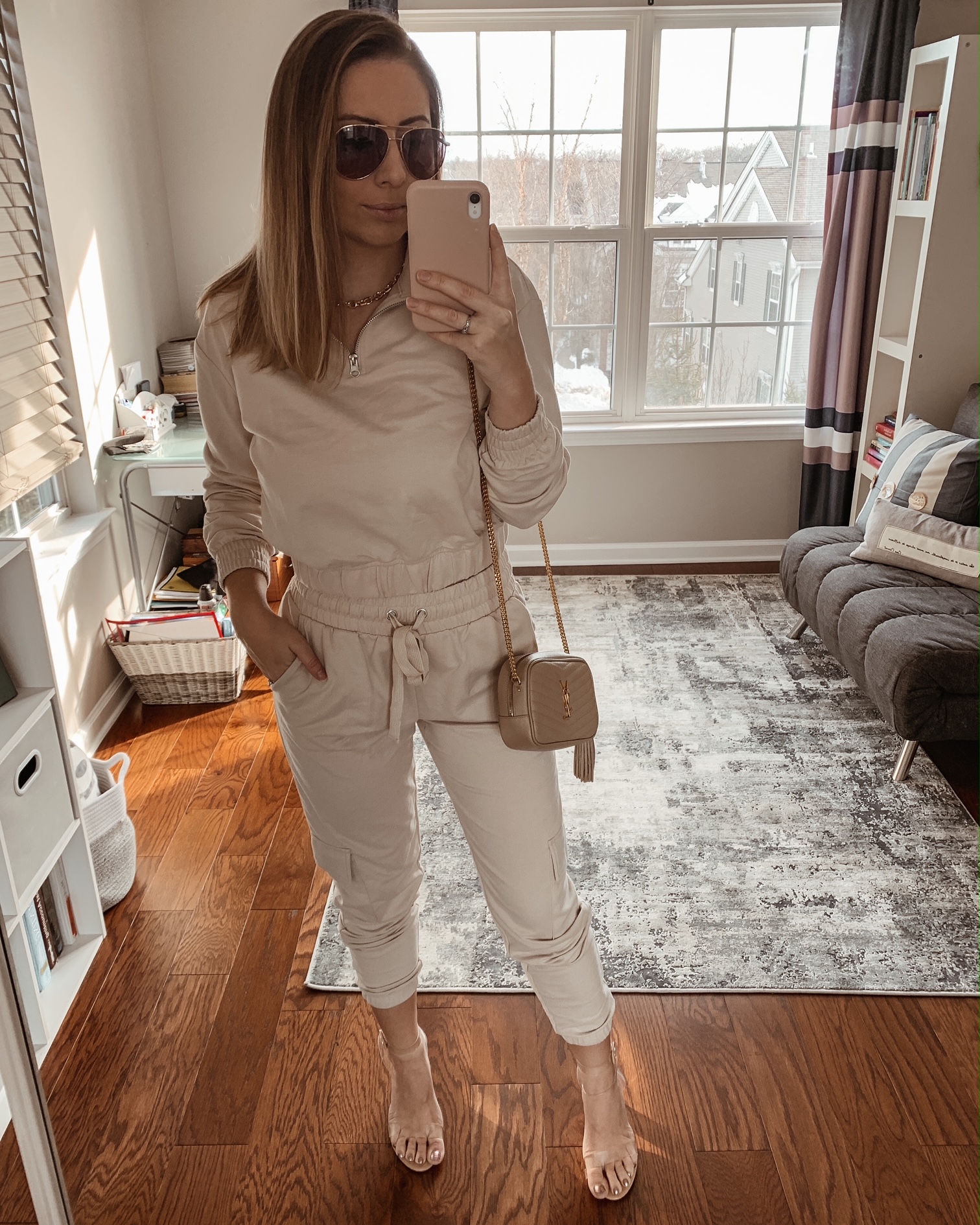 Mirror selfie wearing a beige loungewear set with clear heels, YSL crossbody bag, and sunglasses