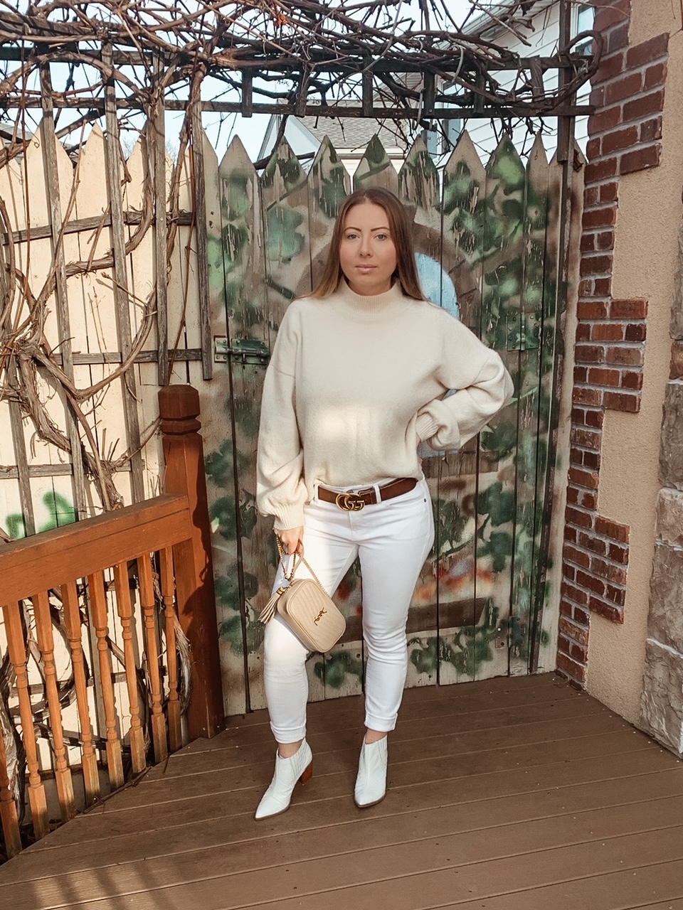 Winter all white outfit with brown leather Gucci belt and beige YSL camera bag